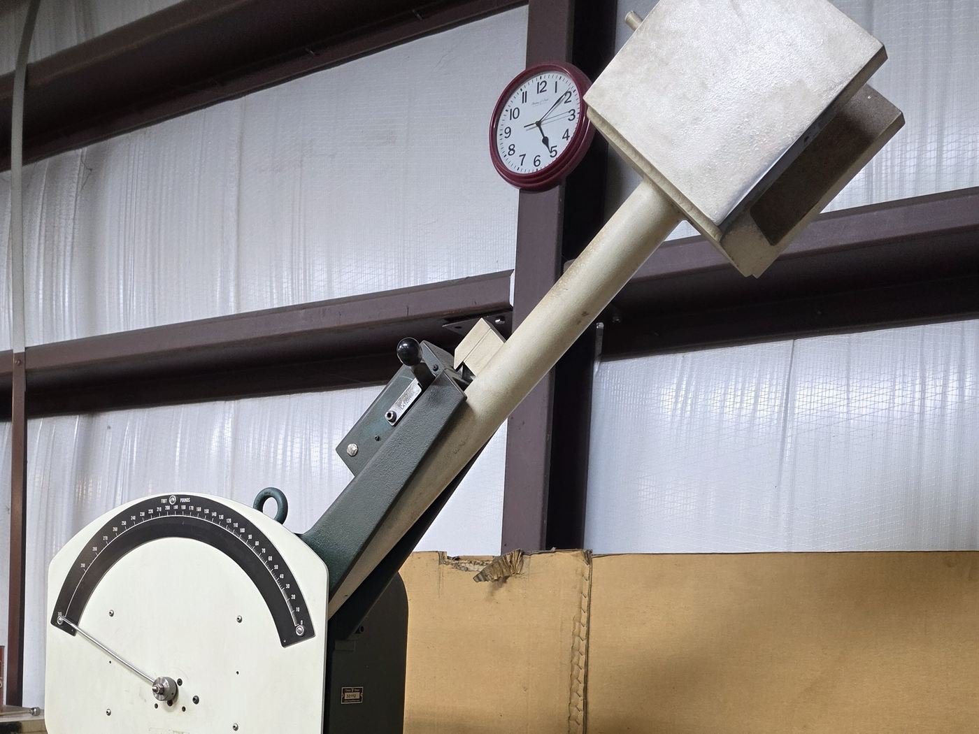 Pendulum impact testing machine with the hammer raised to its release position